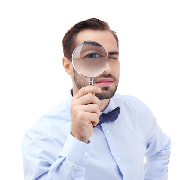 handsome young man with magnifier on white background