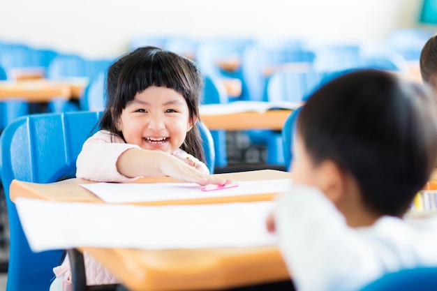 Happy little girl student in the classroom