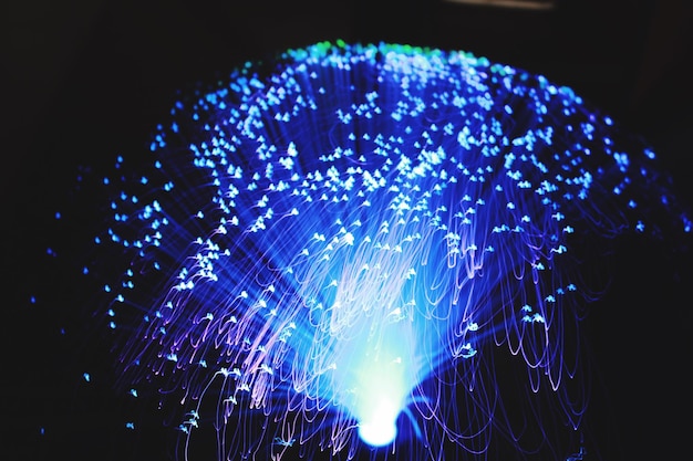 Illuminated fiber optic against black background