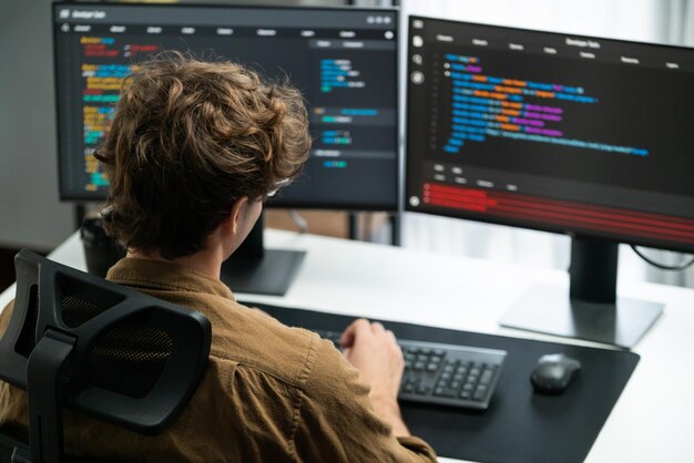 it developer working online software development coding on pc screens gusher