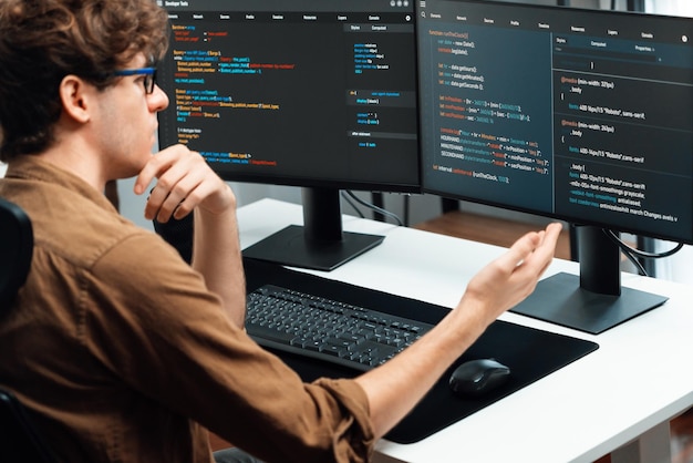 It developer working online software development coding on pc screens gusher