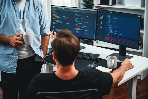 IT developers discussing online software development information on pc screen creating program coding for latest version application on website Concept of brainstorming firmware updated Sellable