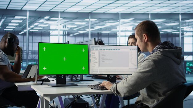 IT expert supervising data center supercomputers using mockup computer monitor