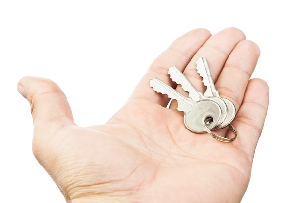 Keys in hand isolated on white