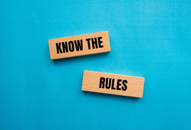 Know the rules words written on wooden blocks with blue background Conceptual know the rules symbol