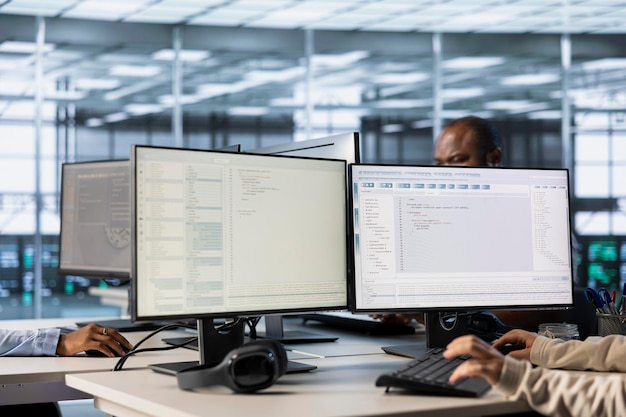 Lines of code running on computer screens in data center used by employees