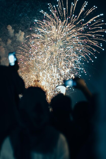 low angle view of firework display at night