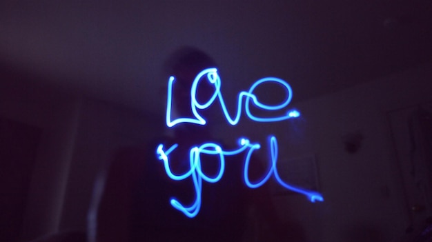Low angle view of love you text light painting at home
