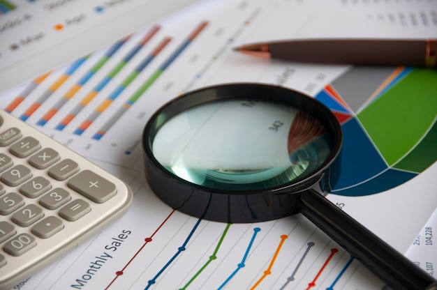 magnifying glass on graph analysis copy space and business analysis concept