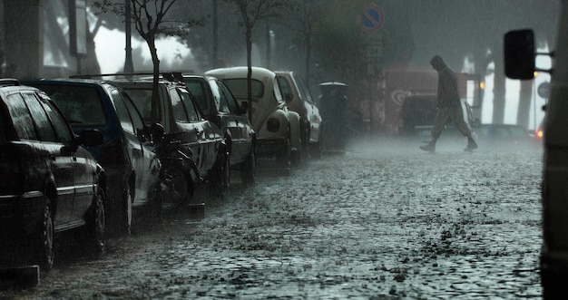 Man crossing road during rainy season
