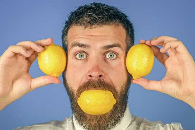 Man eat lemon Fruit and healthy organic food Fynny citrus fruit