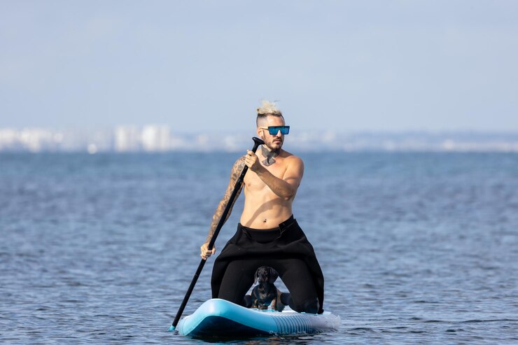 Foto man paddlesurfing with a dog