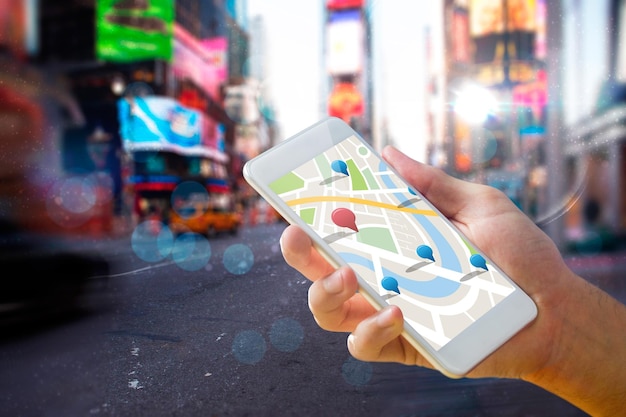 Man using map app on phone against blurry new york street