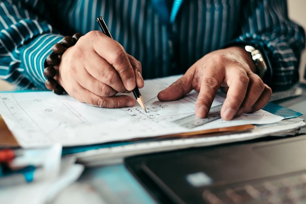 Midsection of man drawing on paper over table