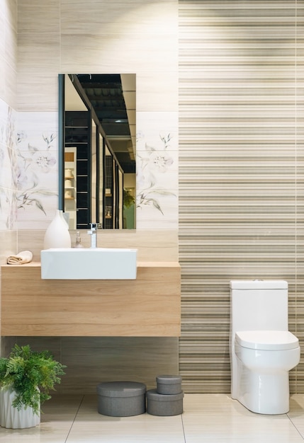 Modern bathroom interior in foreground of counter top washbasin using natural materials.