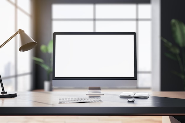 Modern designer table with white computer monitor coffee cup supplies other objects and window with city view in the background Mock up 3D Rendering