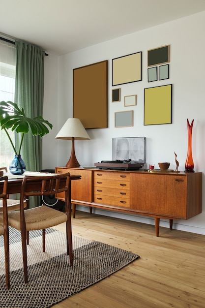 Modern scandinavian home interior of living room with design retro furniture, tropical palm, gallery wall, decoration and elegant personal accessoreis in stylish home decor.