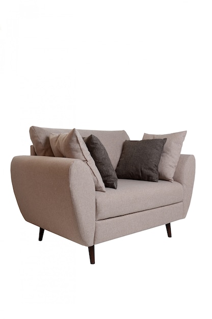 Modern small grey fabric sofa with pillows isolated on white.