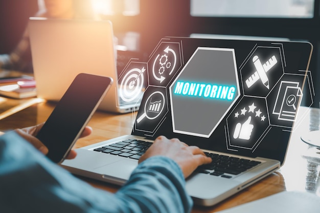 Monitoring process concept Business person working on laptop computer with monitoring process icon on virtual screen