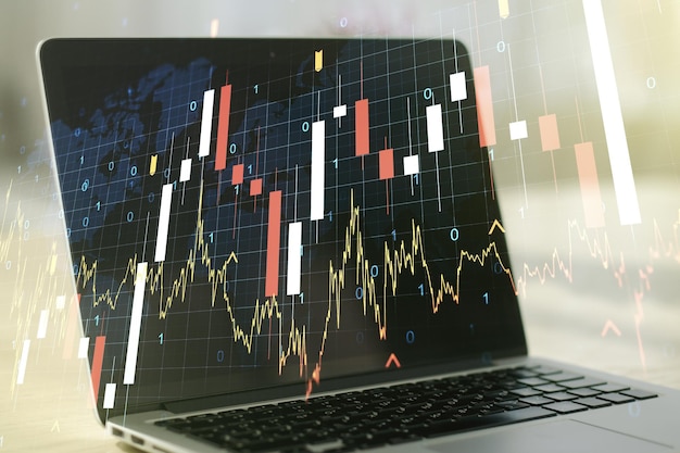 Multi exposure of abstract creative financial graph with world map on modern laptop background forex and investment concept