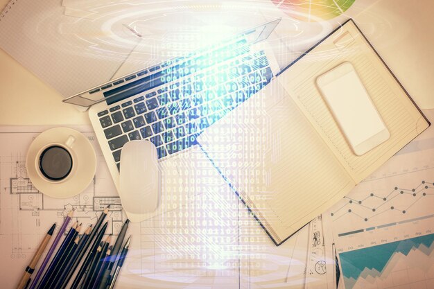 Multi exposure of data drawing hologram over topview of study desk background with computer Concept of technology