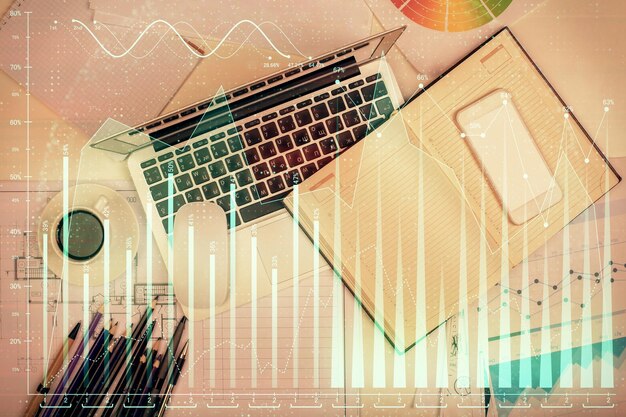 multi exposure of forex chart drawing over table background with computer concept of financial research and analysis top view