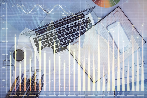 multi exposure of forex chart drawing over table background with computer concept of financial research and analysis top view