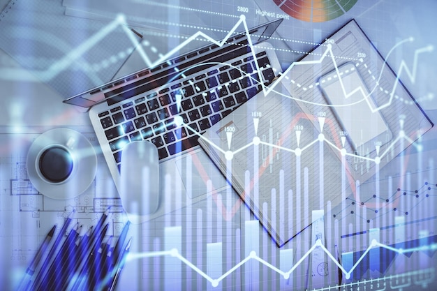 multi exposure of forex chart drawing over table background with computer concept of financial research and analysis top view