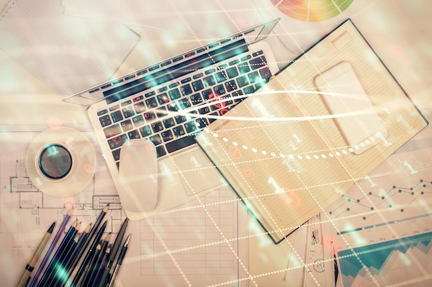 multi exposure of forex chart drawing over table background with computer concept of financial research and analysis top view