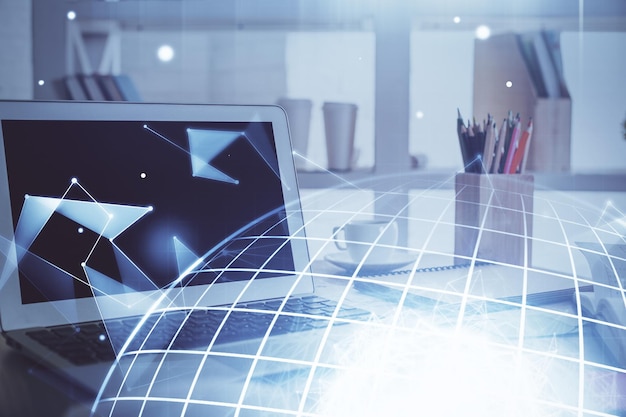 multi exposure of table with computer and world map hologram international data network concept