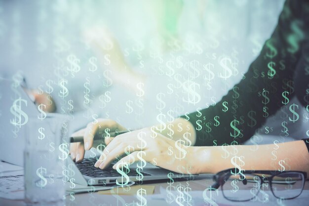 Multi exposure of woman hands typing on computer and financial graph hologram drawing Stock market analysis concept
