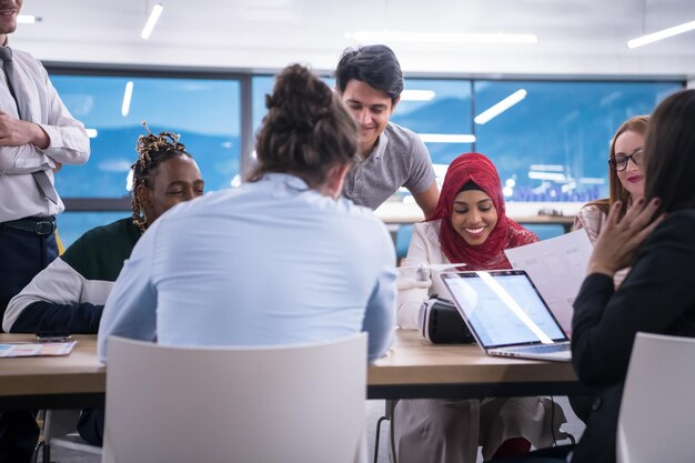 multiethnic startup business team discussing new business plan,working on laptop and tablet computer while learning about drone technology for new business advancement