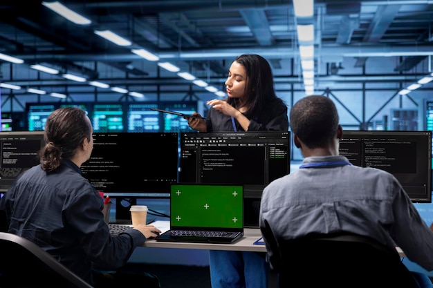 multiracial employees in data center doing disk checks using mockup notebook
