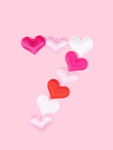 number 7 seven made of glossy atlas hearts isolated on solid pink background alphabet hearts font
