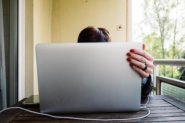 Obscured woman using laptop