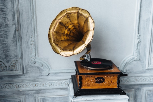 old gramophone with horn speaker stands against ancient 