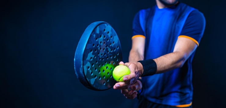 Foto padel tennis player with racket man athlete with paddle racket on black background sport concept download a high quality photo for sports website