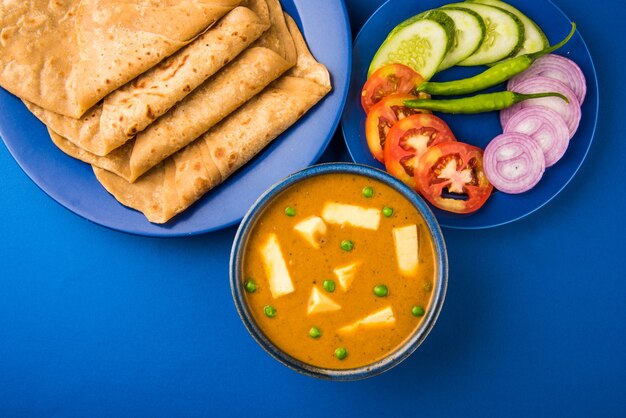 Paneer Butter Masala is famous indian food recipe made using cottage cheese, served with flat bread also known as roti or chapati. selective focus