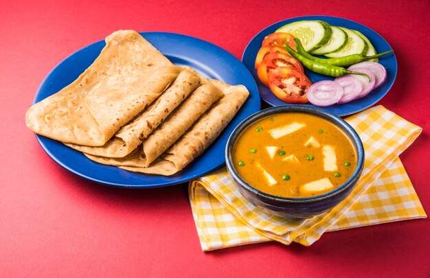 Paneer Butter Masala is famous indian food recipe made using cottage cheese, served with flat bread also known as roti or chapati. selective focus