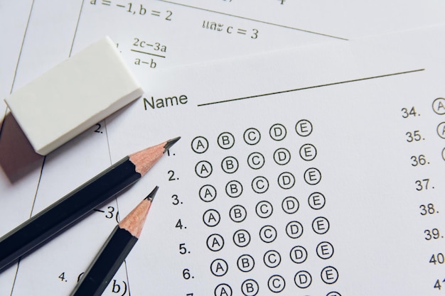 Pencil and eraser on answer sheets or standardized test form with answers bubbled