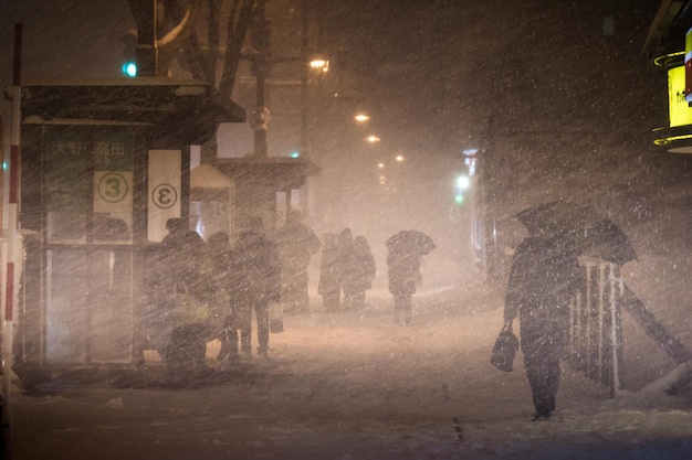 People on street in winter at night