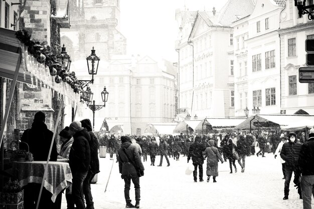 people walking on street against buildings during winter