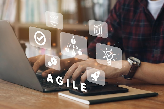 Person working on computer with icons of Agile development methodology concept on virtual screen Technology concept xA