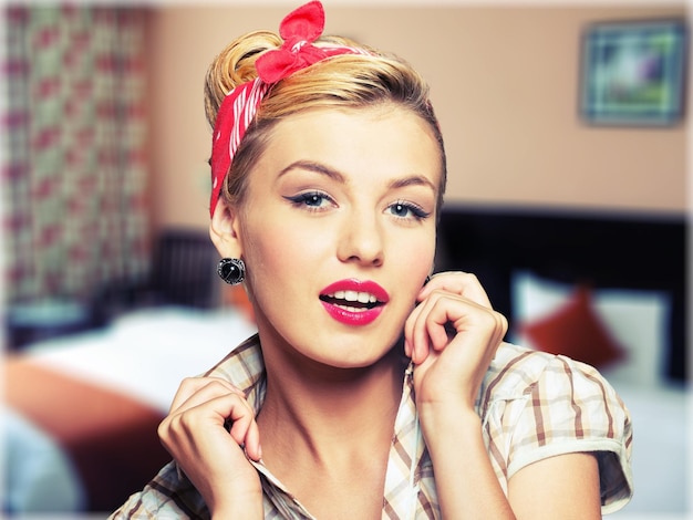 Pinup style portrait of surprised blonde woman sepia toned