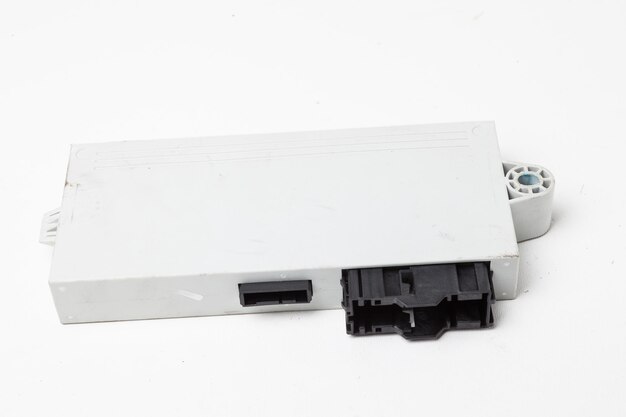 Plastic electronic control unit with black and blue connectors on a white isolated background