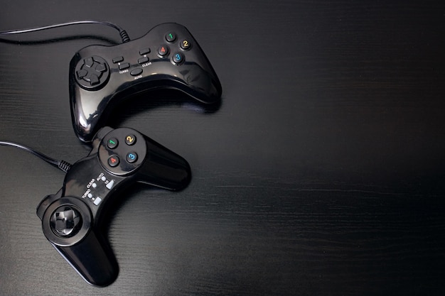 Playing joystick on a black wooden table