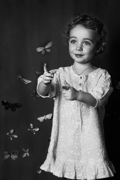 Portrait of a girl standing against the wall