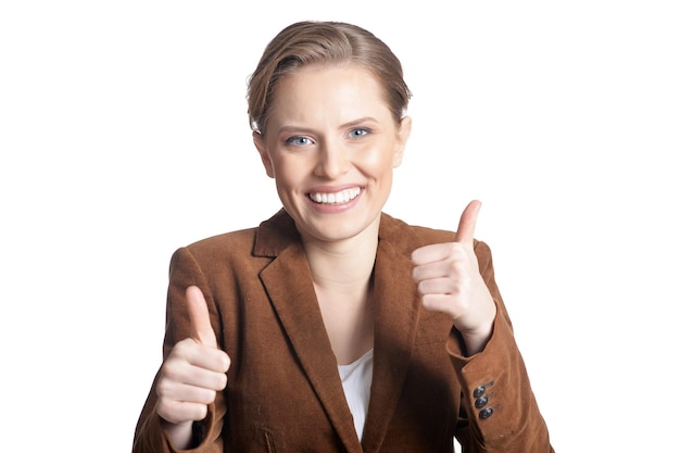 Portrait of a young woman looking at camera and showing thumbs up