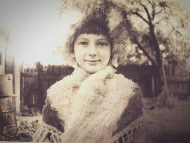 Portrait of girl in warm cloth standing outdoors