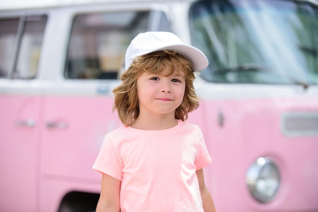 Portrait of kid boy in nature park or outdoors close up face of happy child playing outdoors in
